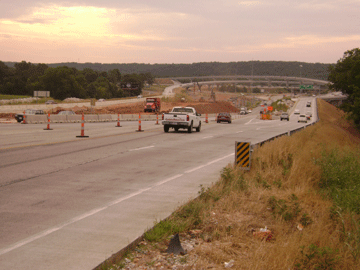 Dump trucks enter and leave work areas along U.S. 60 west of U.S. 65 to deliver rock and dirt.