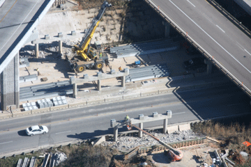 Contractor crews install extensions on the bridge caps for the new southbound Route 65 bridge over Route 60.  The bridge is being rehabilitated and raised